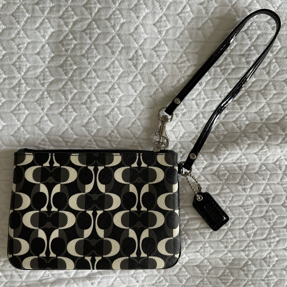 Coach Wristlet.  Black Print with silver trim.  New-Never used.